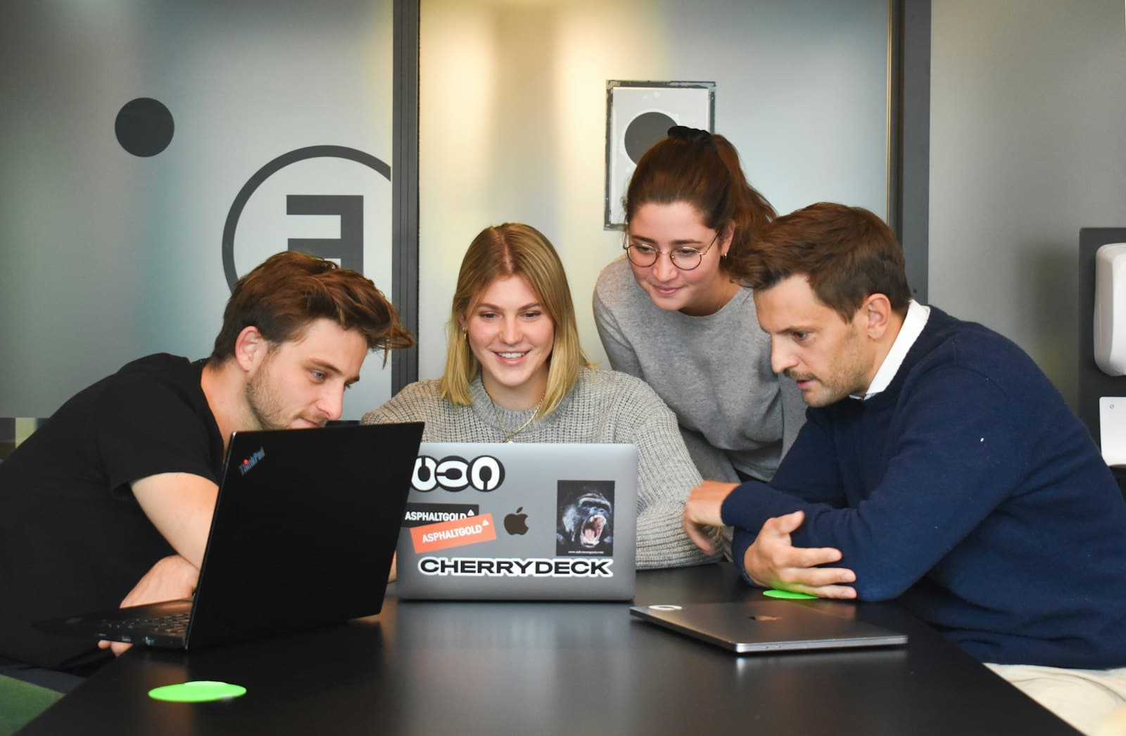 A small software team working together around a laptop