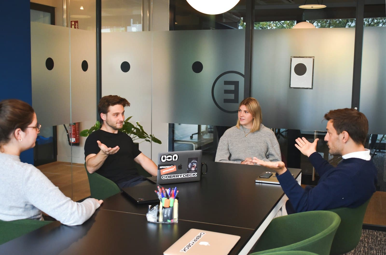 Consultants and a client discussing a project around a table